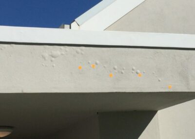 Damp bubbling paint at the front entrance portico after builder's remedial works