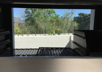 Glass-backed barbecue at eco house